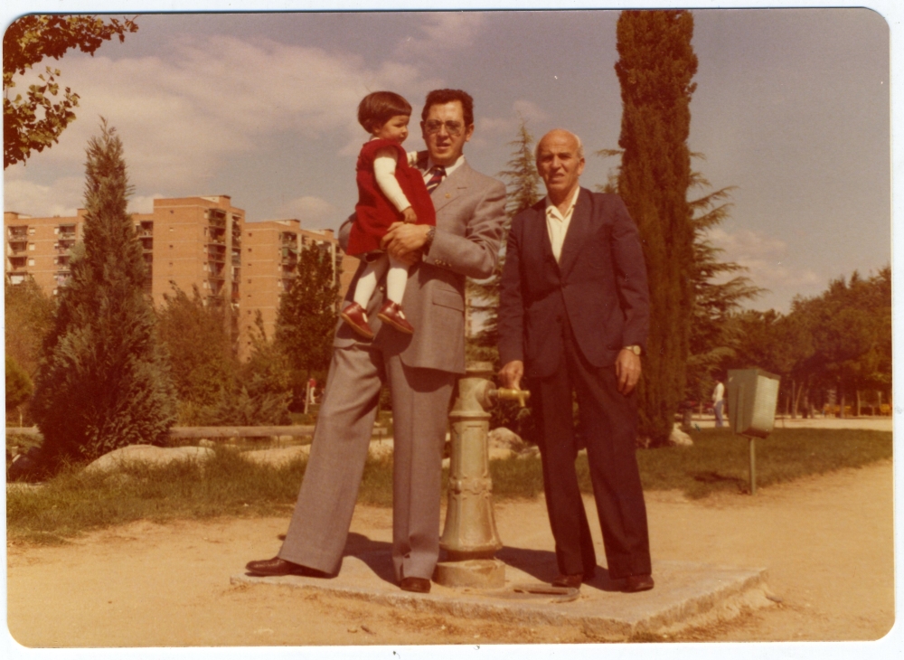 Elena con su padre y abuelo junto a una fuente del Parque Aluche